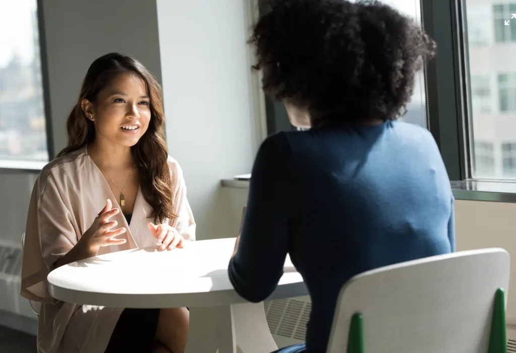 Mentoring administrator consulting with a mentor colleague.