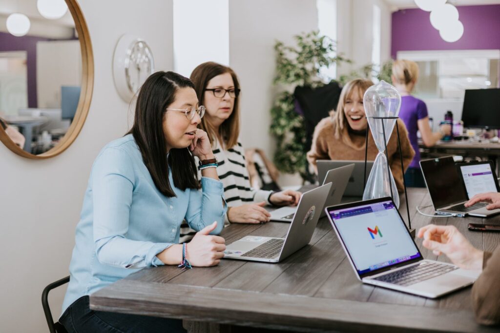 An image of women at a table talking while discussing ERG metrics.