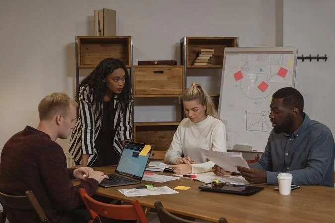 Group meeting around a table for leadership development.
