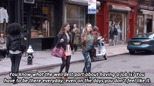 Two women walking on a city street with a humorous quote about having a job.
